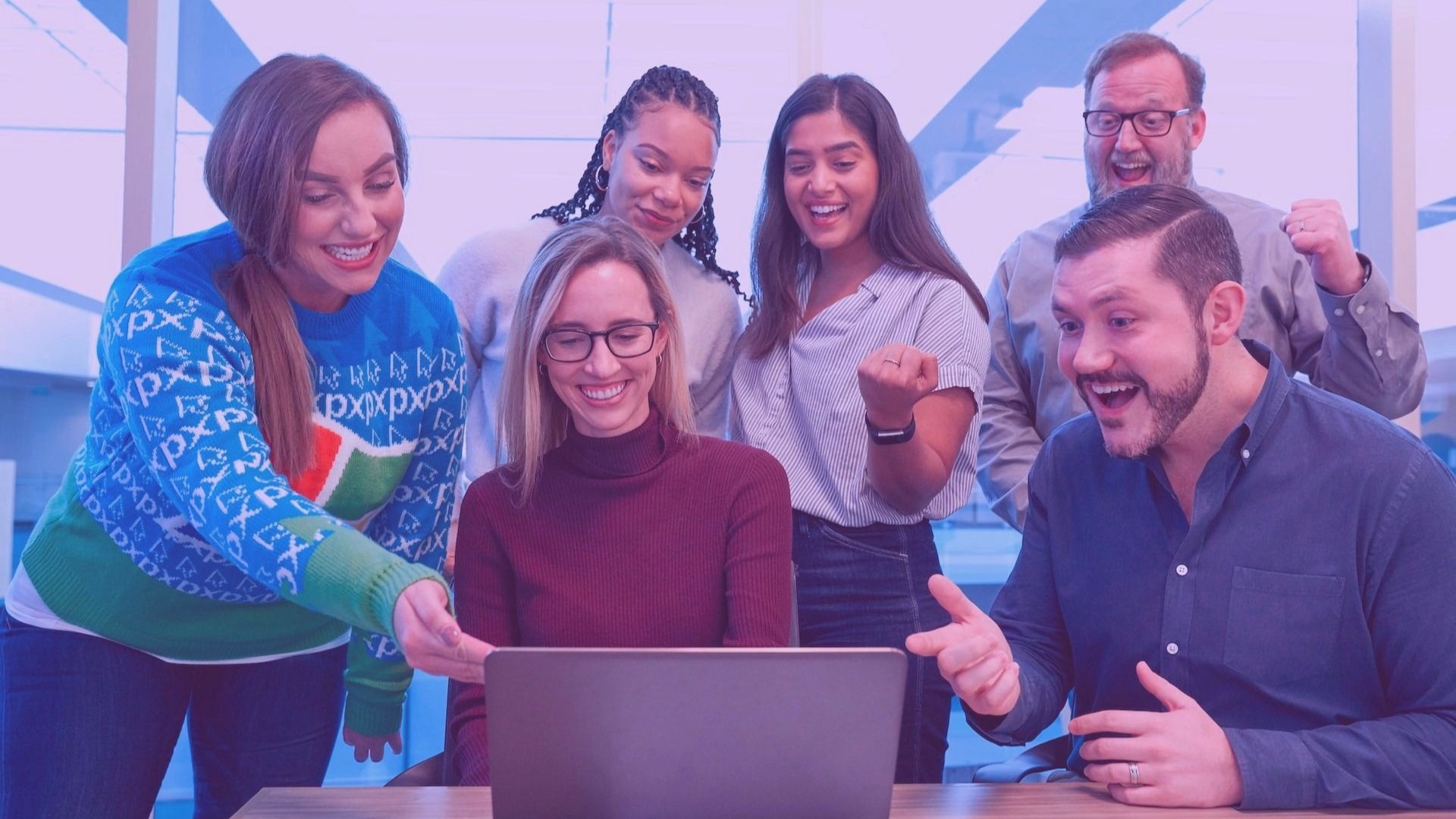 small team in front of a laptop cheering because they found the best free project management tools